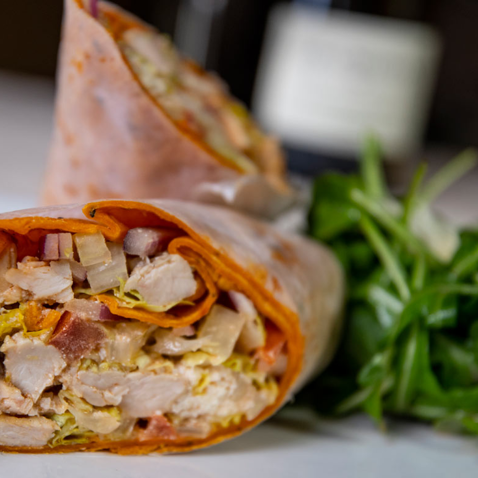 Close-up of chicken wrap and greens