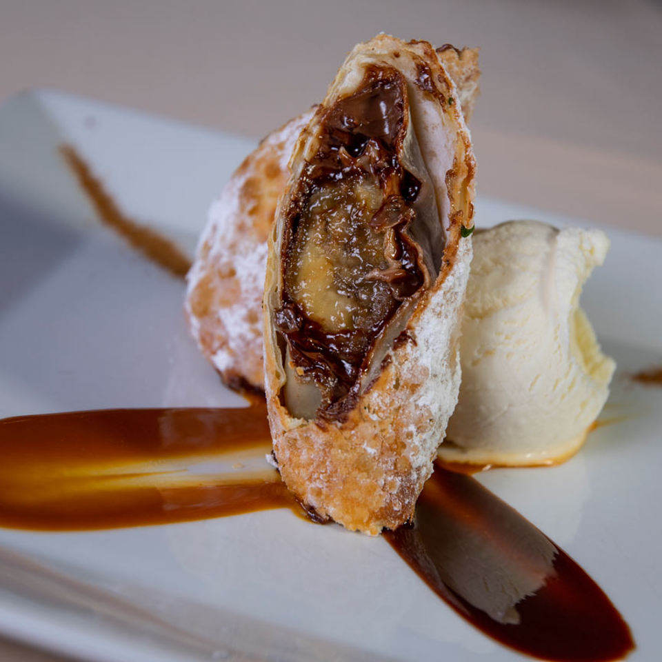 Close-up of chocolate-filled pastry and ice cream