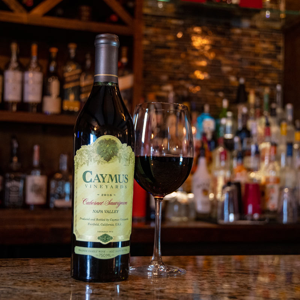Caymus Cabernet Sauvignon bottle and glass