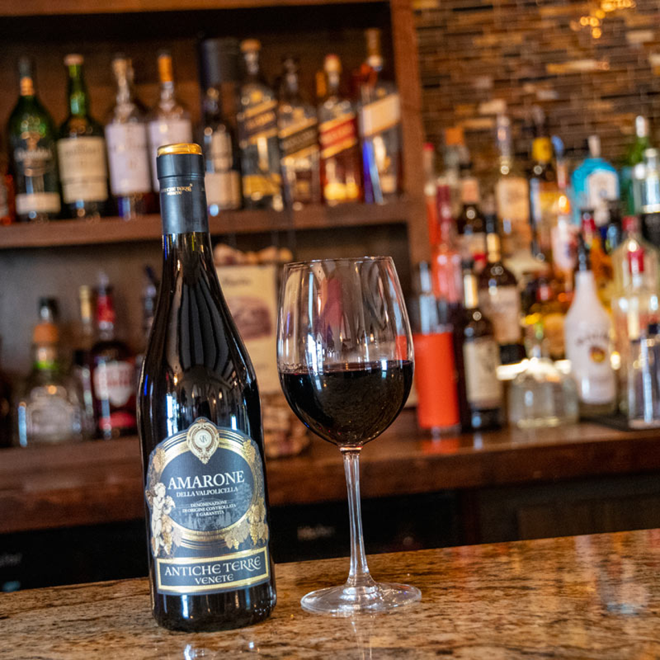 Amarone wine bottle and glass at the bar