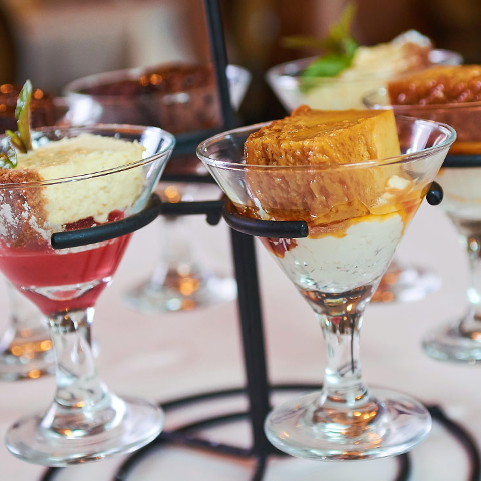 Dessert flight served in stemmed glasses
