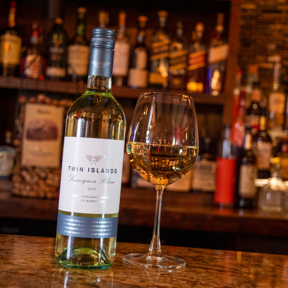 Sauvignon Blanc bottle and glass at the bar