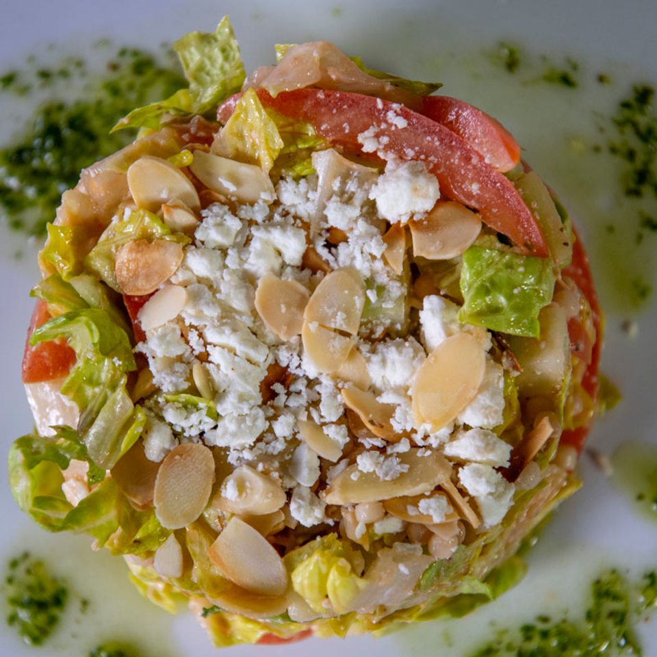 Overhead view of salad with cheese and sliced almonds