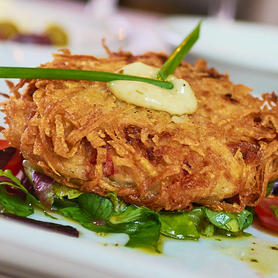 Golden crusted entree over mixed greens