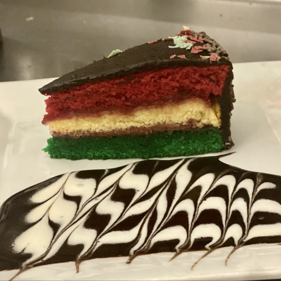 Tricolor cake slice with chocolate coating