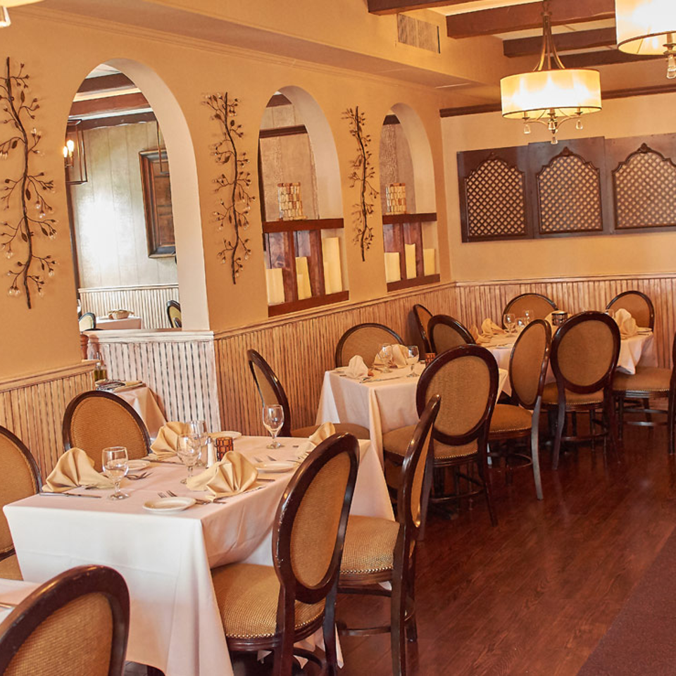 Dining room tables beneath warm pendant lights