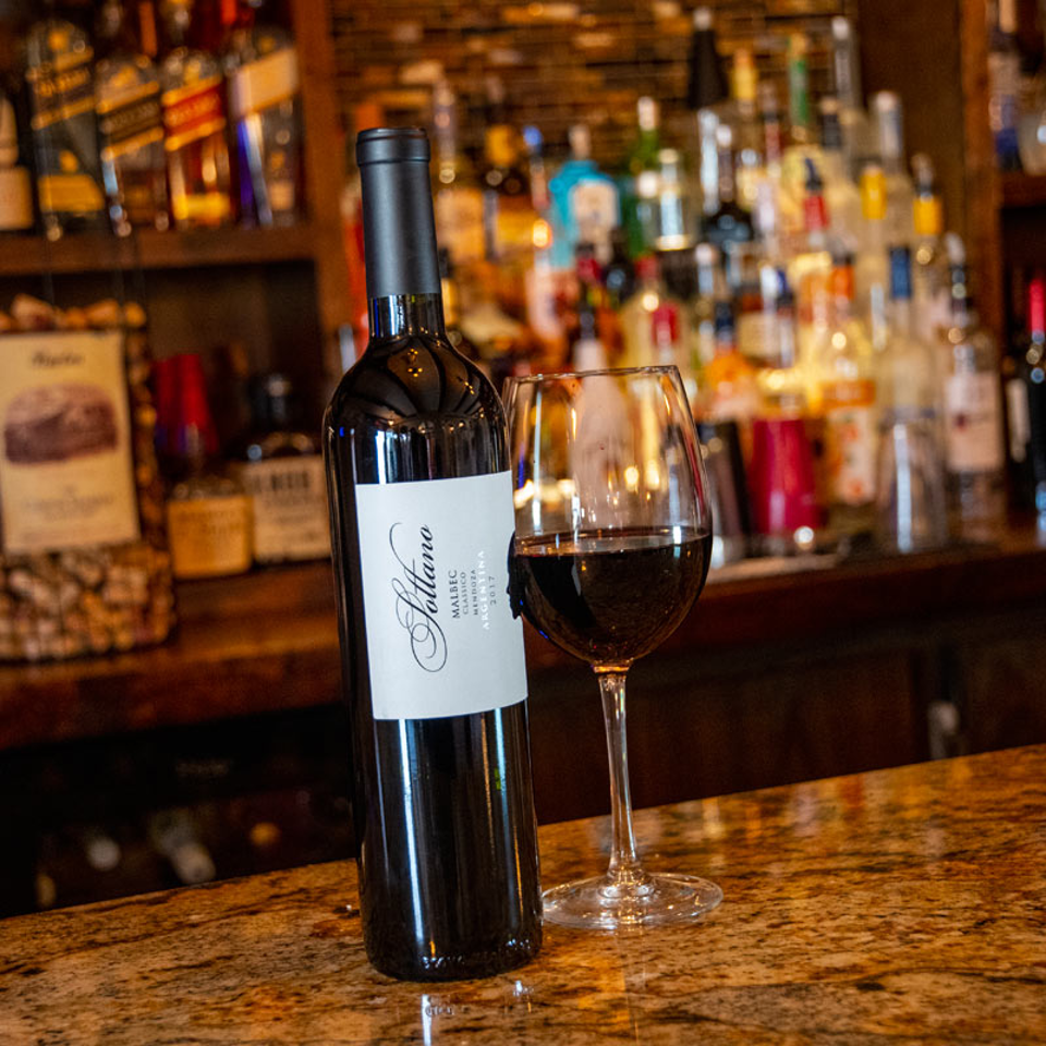 Malbec bottle and glass at the bar